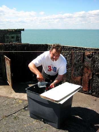 Big Phil fills solar shower tank